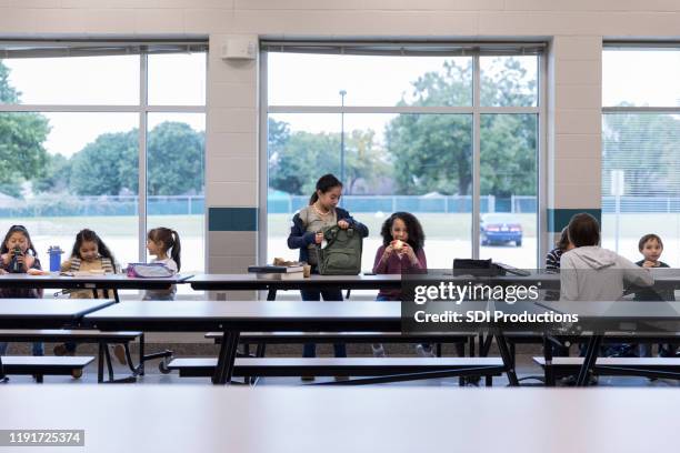 group of schoolchildren eating lunch - kid school lunch stock pictures, royalty-free photos & images