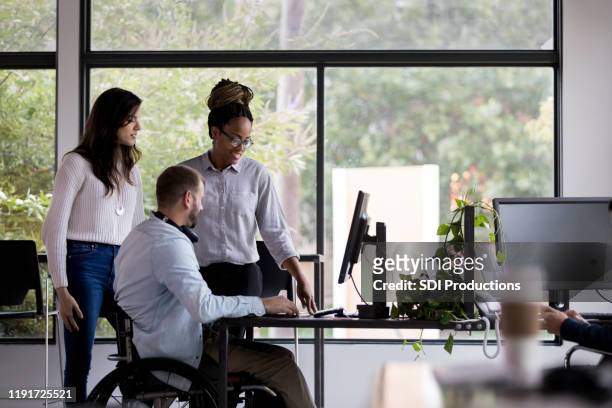 team of coworkers working together - persons with disabilities stock pictures, royalty-free photos & images