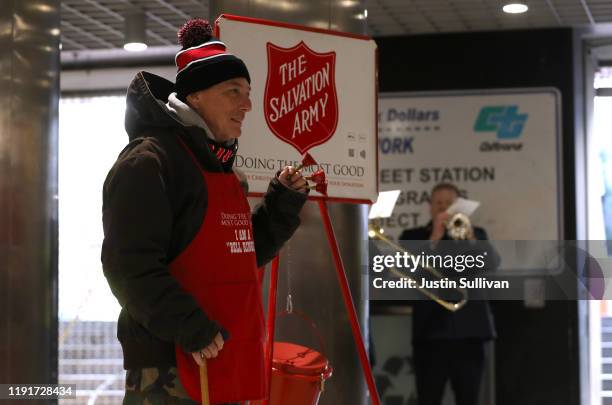 Salvation Army volunteer bell ringer San Arnold rings bells as he solicits donations at the Powell Street Bay Area Rapid Transit station on December...
