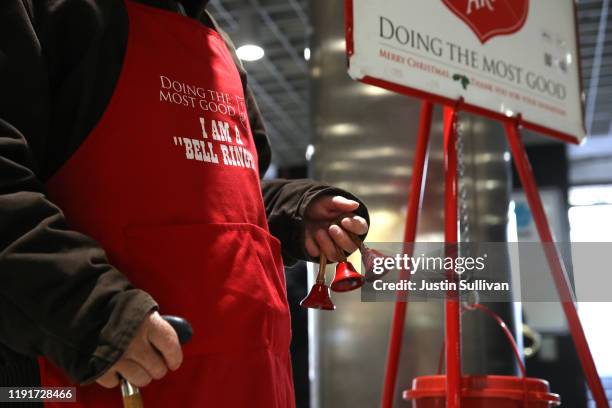 Salvation Army volunteer bell ringer San Arnold rings bells as he solicits donations at the Powell Street Bay Area Rapid Transit station on December...