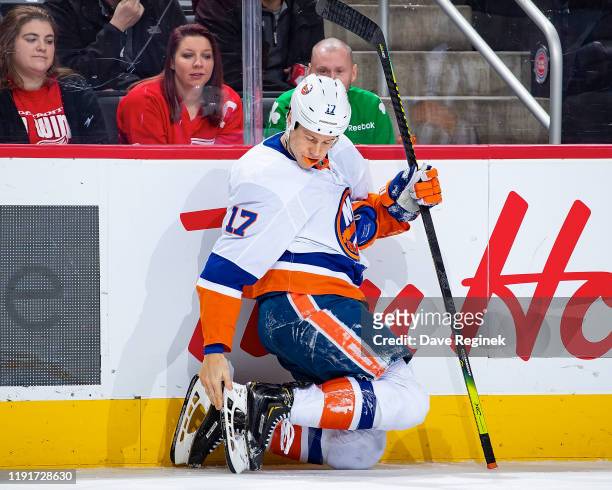 Matt Martin of the New York Islanders checks his skate blade after falling during an NHL game against the Detroit Red Wings at Little Caesars Arena...