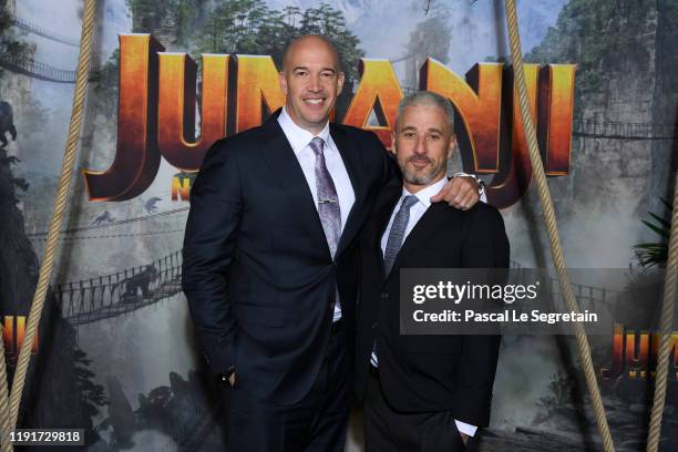 Producer Matt Tolmach and a guest attend the photocall of "Jumanji : Next Level" film at le Grand Rex on December 03, 2019 in Paris, France.