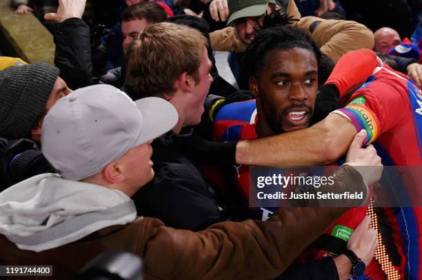 Jeffrey Schlupp of Crystal Palace celebrates with fans after scoring his team's first goal during the Premier League match between Crystal Palace and...