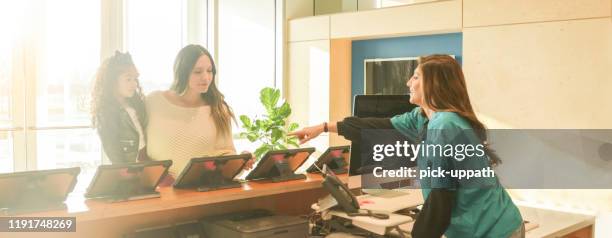 receptionist lobby with patients - lobby screen stock pictures, royalty-free photos & images