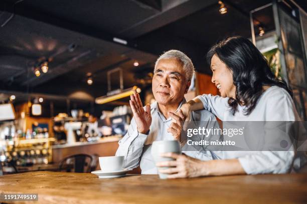 spending retirement days in good mood together - asian senior couple stock pictures, royalty-free photos & images