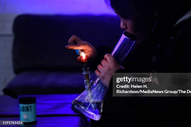 Client lights up a bong at the Tetra Private Lounge and Garden on December 1, 2019 in Denver, Colorado. The lounge allows open smoking and...