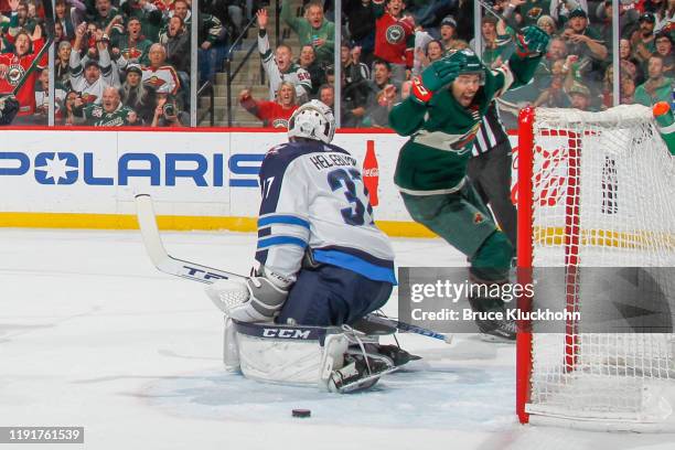 Matt Dumba of the Minnesota Wild celebrates his teammates goal against Connor Hellebuyck of the Winnipeg Jets during the game at the Xcel Energy...