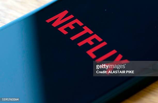In this file photo taken on July 10, 2019 the Netflix logo is seen on a phone in this photo illustration in Washington, DC. - US importers of French...