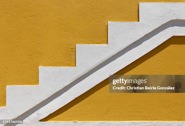 vibrant yellow wall of bo-kaap, cape town - south africa - christian beirle gonzález stock pictures, royalty-free photos & images