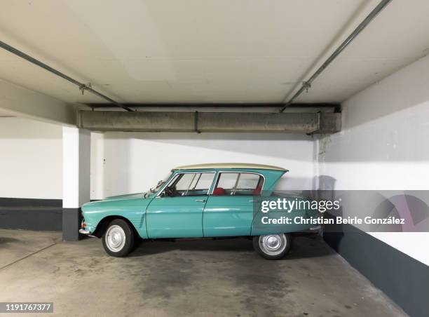 parked vintage car in munich, germany - parking garage stock-fotos und bilder