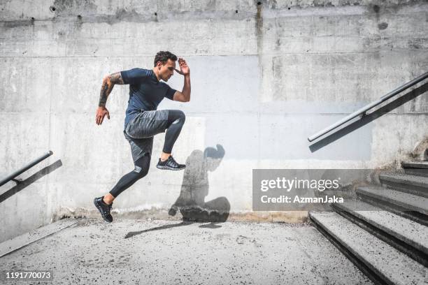 experienced male athlete running stairs with high knees - toughness man stock pictures, royalty-free photos & images