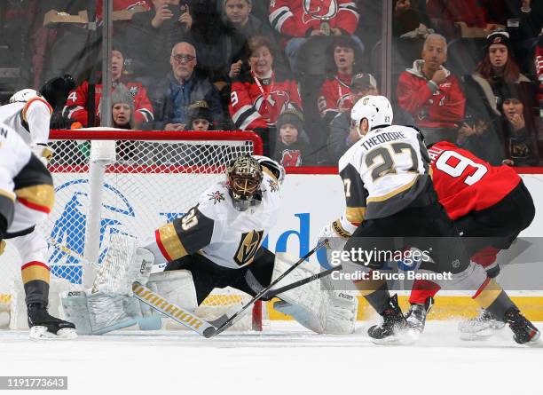 Malcolm Subban of the Vegas Golden Knights makes the first period save against Taylor Hall of the New Jersey Devils at the Prudential Center on...