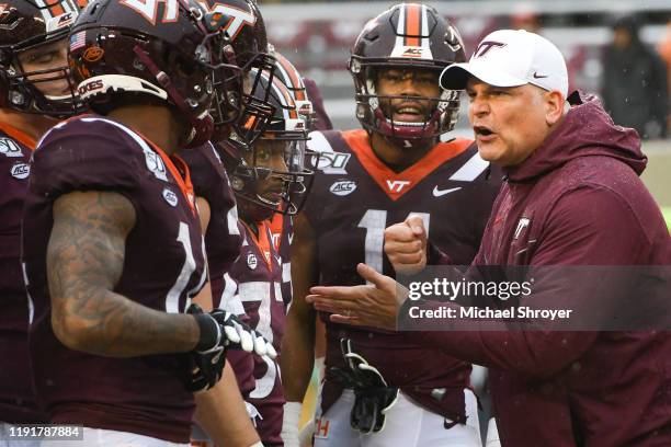 Head coach Justin Fuente of the Virginia Tech Hokies huddles with his team prior to the game against the Pittsburgh Panthers at Lane Stadium on...