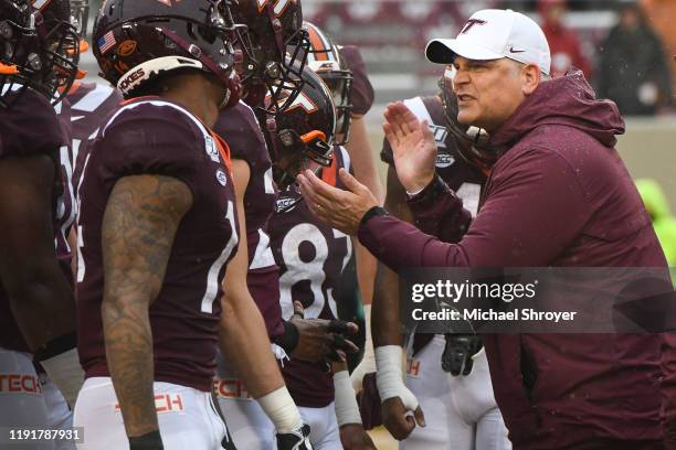 Head coach Justin Fuente of the Virginia Tech Hokies huddles with his team prior to the game against the Pittsburgh Panthers at Lane Stadium on...