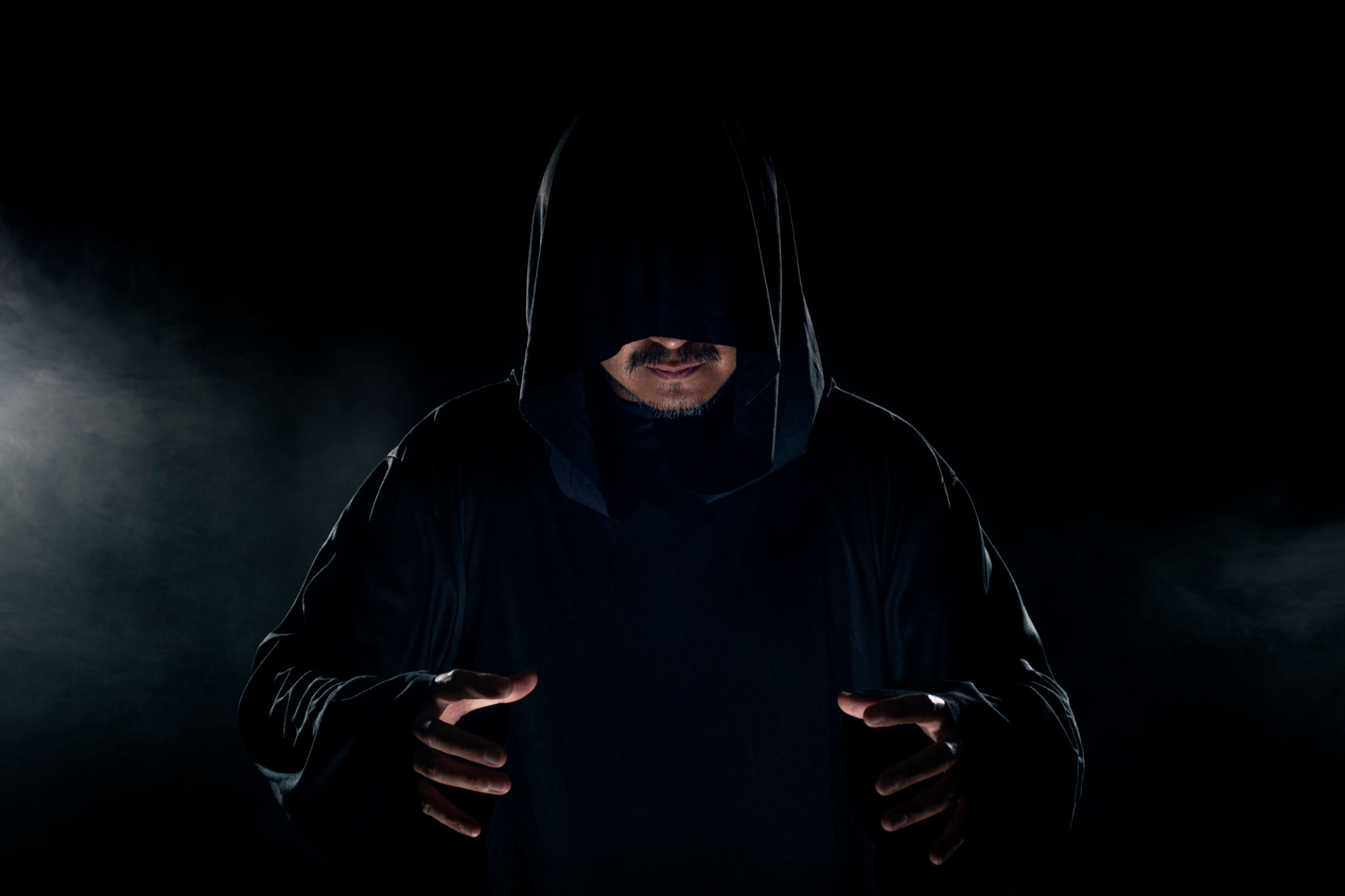 Cult Leader Wearing a Dark Robe with Smoky Background Cult Leader Wearing a Dark Robe with Smoky Background