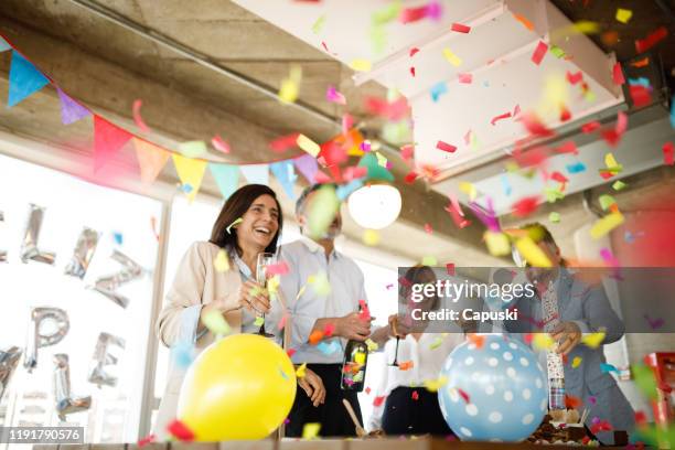 celebrating birthday with confetti - office party imagens e fotografias de stock