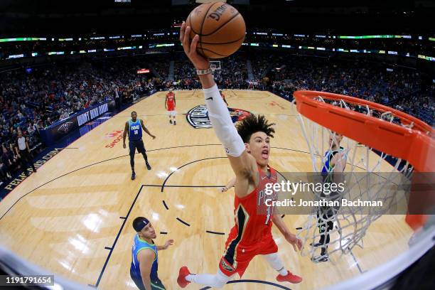 Jaxson Hayes of the New Orleans Pelicans dunks as Seth Curry of the Dallas Mavericks defends during the second half at the Smoothie King Center on...