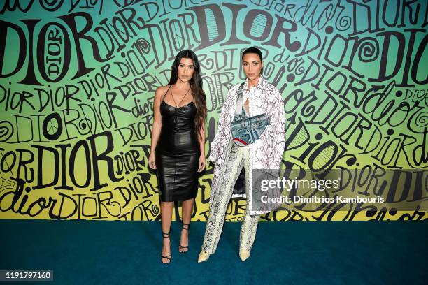 Kourtney Kardashian and Kim Kardashian West attend the Dior Men's Fall 2020 Runway Show on December 03, 2019 in Miami, Florida.