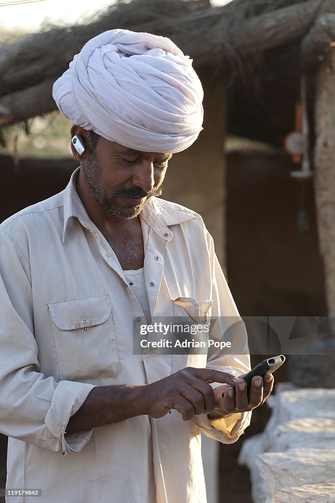 Village tribesman using smartphone