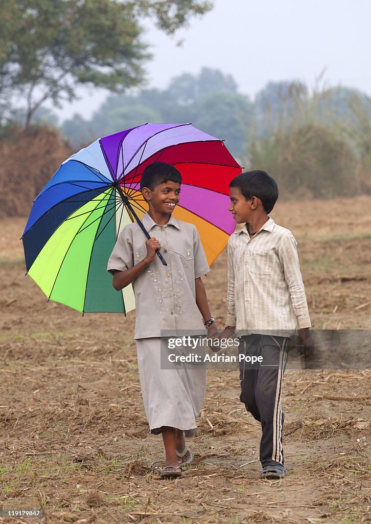 Brother & sister walking through field