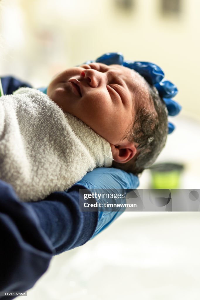 Newborn Hispanic Baby First Bath at Hospital