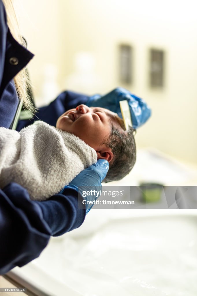 Newborn Hispanic Baby First Bath at Hospital