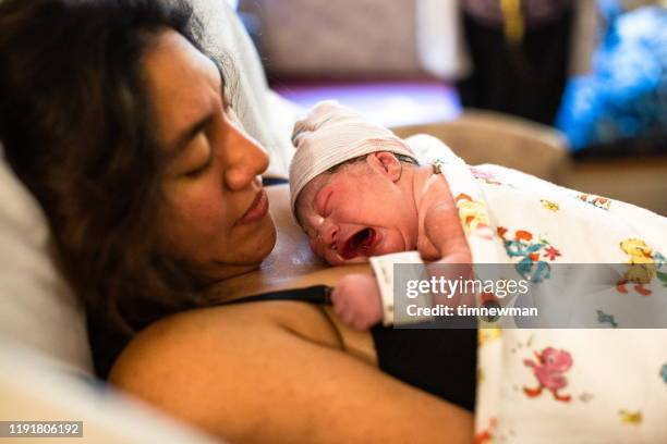 mother and newborn baby in hospital bed bonding - moms crying in bed stock pictures, royalty-free photos & images