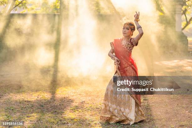 traditional indian woman is light sunset and frog. - indian wedding dress stock pictures, royalty-free photos & images