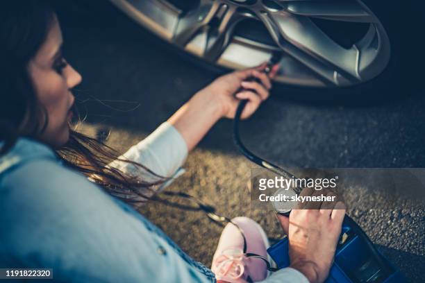 measuring pressure in a car tire. - air serbia stock pictures, royalty-free photos & images