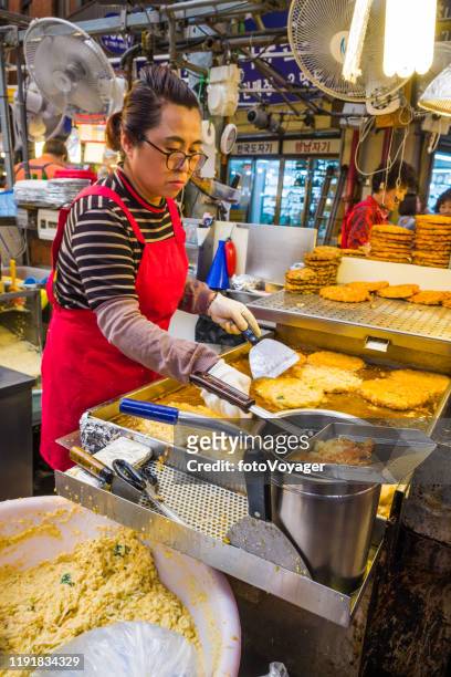 seoul woman chef cooking traditional street food in market korea - chef market stock pictures, royalty-free photos & images