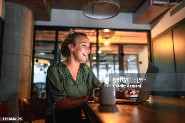 laughing young businesswoman video conferencing on laptop - business casual stock pictures, royalty-free photos & images