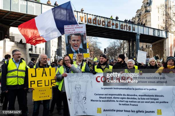 Demonstrators from the Yellow Vests movement are holding a banner that reads &quot;Collabo don't commit suicide, prison awaits you&quot; this...