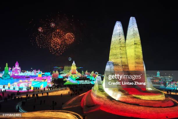 Fireworks set off above the ice sculptures illuminated by coloured lights at Harbin ice and snow world during the opening ceremony of the 36th Harbin...