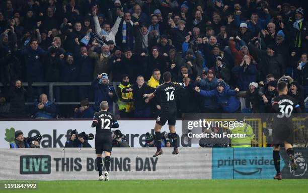 City player Rodrigo Hernandez celebrates in front of the City fans and photographers as an advertising board displays Amazon Prime during the Premier...