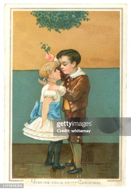 victorian christmas card with two children kissing under the mistletoe, 1883 - mistletoe stock illustrations