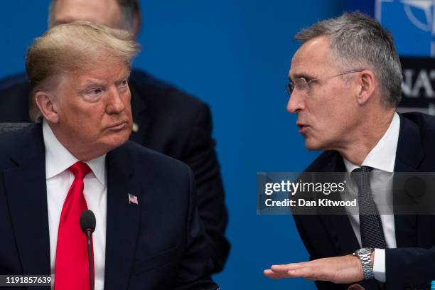 President Donald Trump speaks with Jens Stoltenberg, Secretary General of NATO as they attend the NATO summit at the Grove Hotel on December 4, 2019...