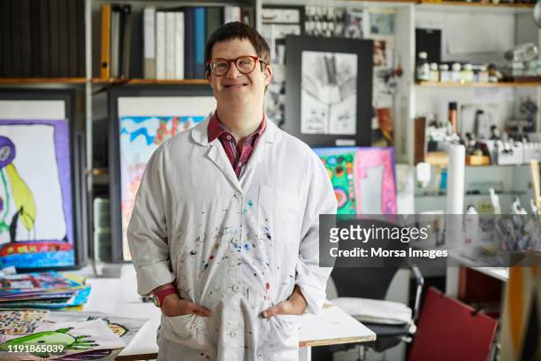 Confident disabled male standing in art studio