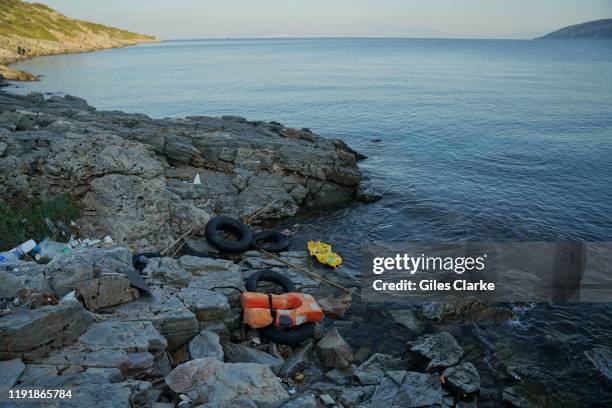 November 29, 2019: At the edge of the Aegean sea, remnants of refugee journeys litter the sea shore.