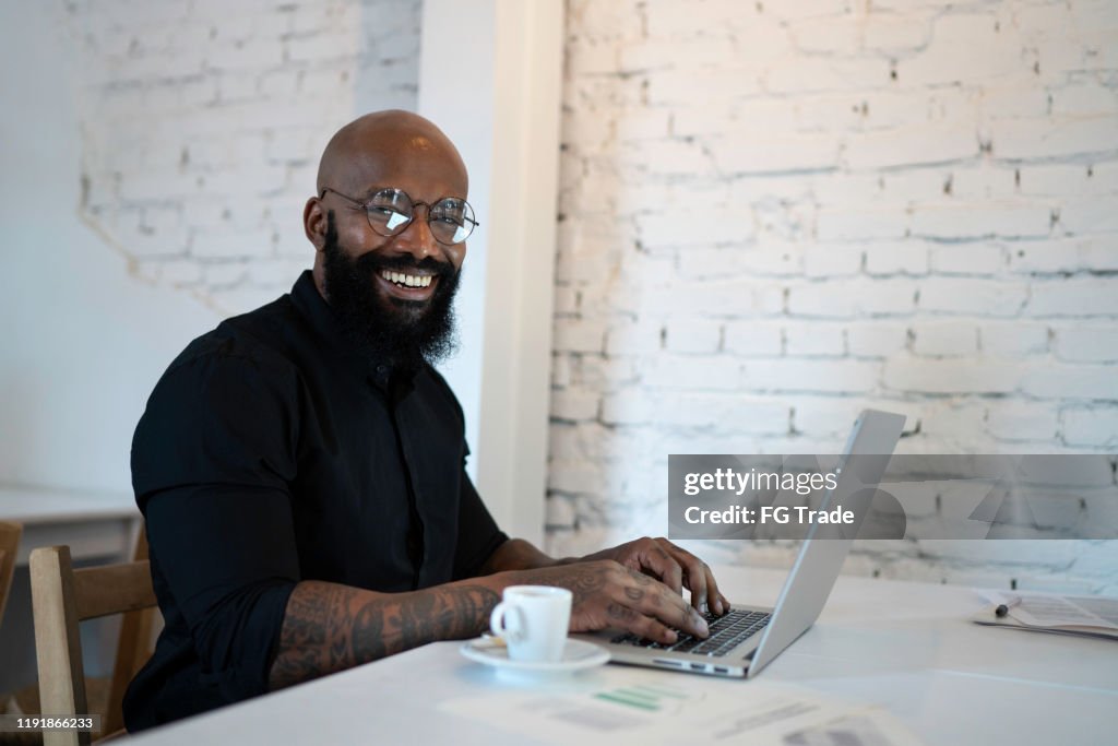 Portrait of a businessman working in a cafeteria