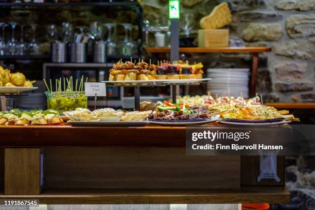 tapas and pinxos in a bar in san sebastian spain - san sebastian stock pictures, royalty-free photos & images