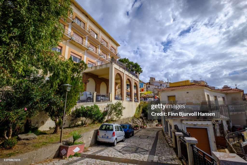 Castelmola, Sicily, Italy - November 8, 2019: Hotel, old buildings and narrow road in Castelmola center