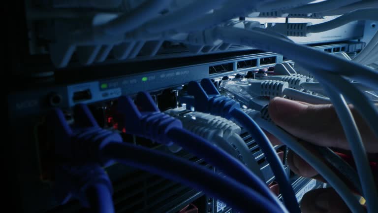 https://media.gettyimages.com/id/1191880544/video/it-administrator-plugs-in-rj45-internet-connector-into-lan-router-switch-information.jpg?b=1&s=640x640&k=20&c=5QLw3iEHkYqE3mGOLX0iWjotyaA5htt01yG2IWzYp1U=