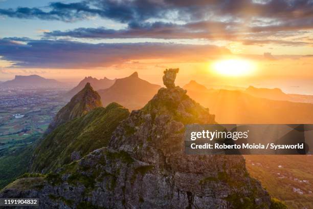 sunset on le pouce mountain and indian ocean, aerial view, mauritius - mauritius stockfoto's en -beelden