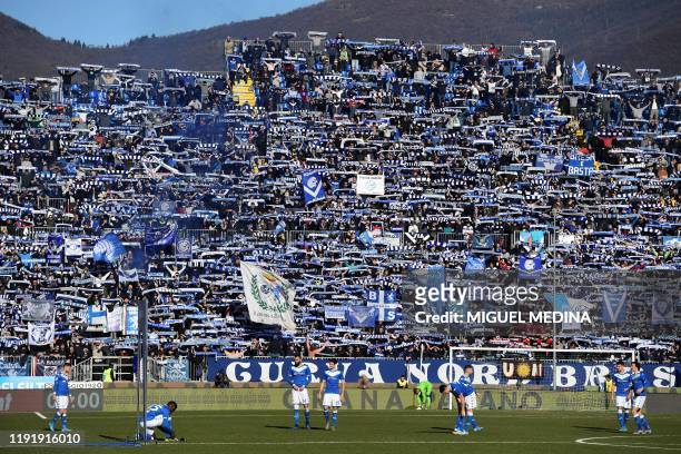 Brescia supporters hold their team scarfs during the Italian Serie A football match between Brescia and Lazio on January 5, 2020 at the...