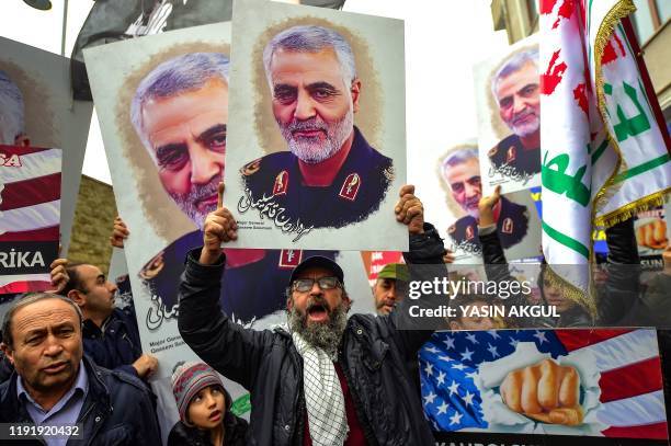 Protesters hold pictures of Iranian commander Qasem Soleimani, during a demonstration outside the US consulate in Istanbul, on January 5 two days...