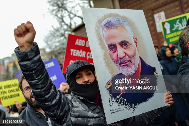 Protester holds a picture of Iranian commander Qasem Soleimani, during a demonstration outside the US consulate in Istanbul, on January 5 two days...