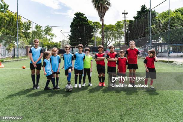 two mixed soccer teams in a row together - boy soccer team stock pictures, royalty-free photos & images