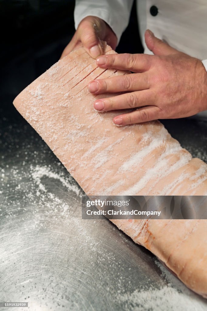 Traditional Danish dish of Flæskesteg or Roast Pork being prepared.