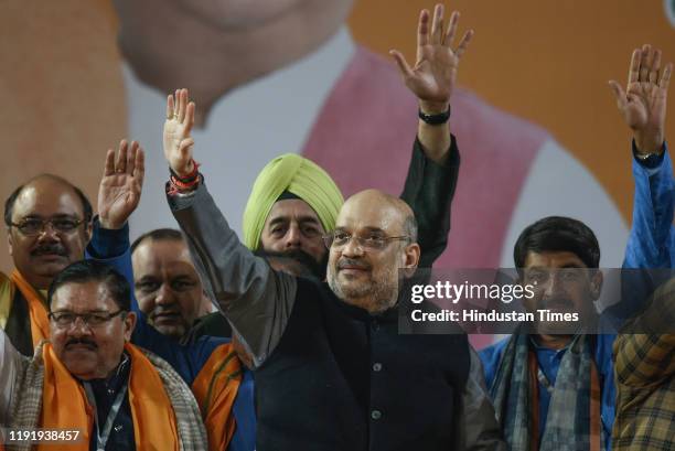 Home Minister Amit Shah, BJP working president J P Nadda and Delhi BJP president Manoj Tiwari along with others wave towards Bharatiya Janata Party's...