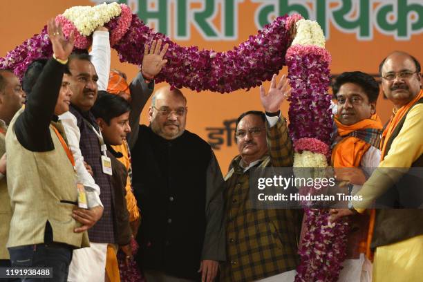 Home Minister Amit Shah and BJP working president J P Nadda with other senior ministers are garlanded during Bharatiya Janata Party's booth-level...